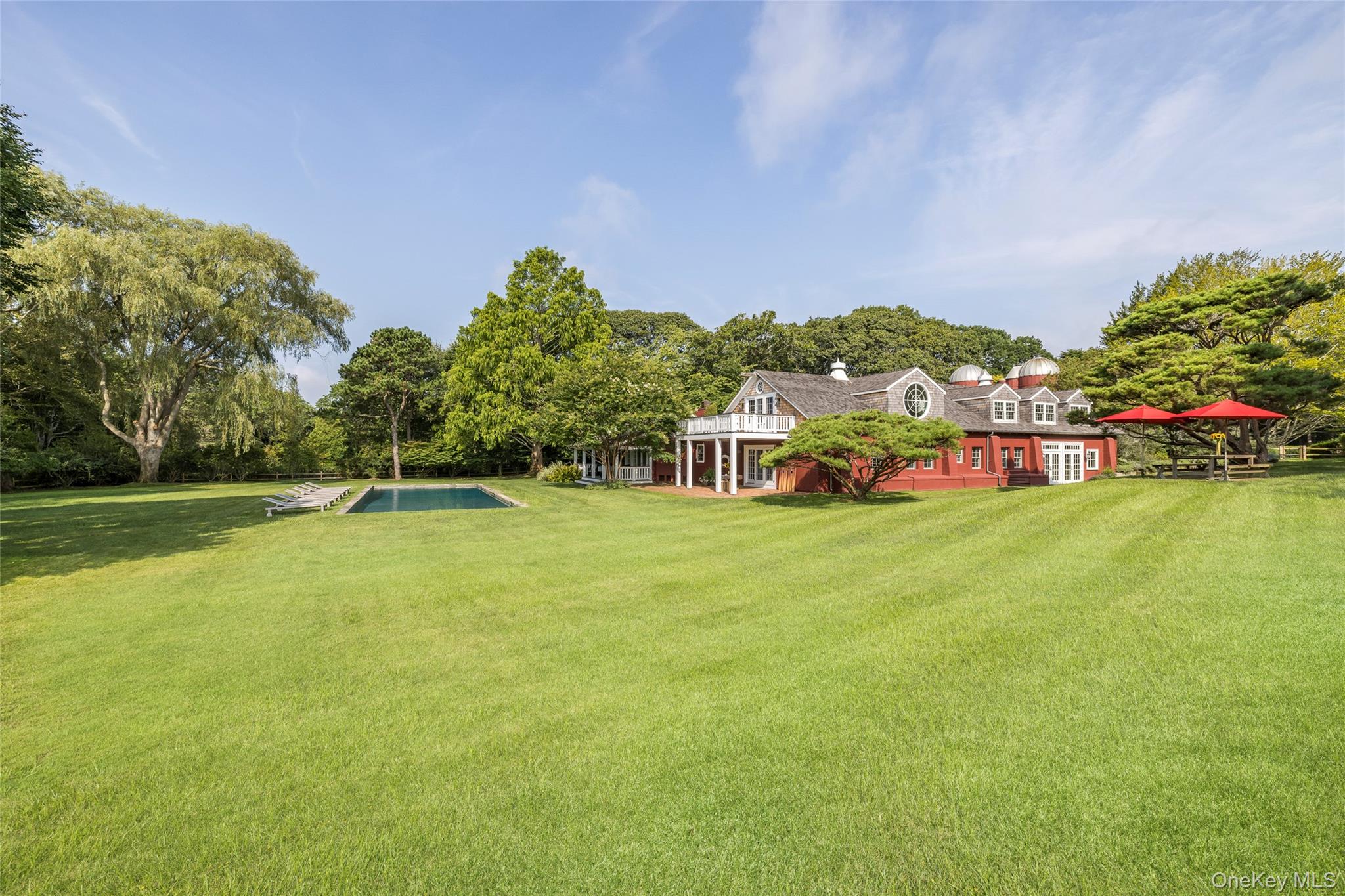 26 Ruxton Road East Hampton, NY 11937 - Photo 36 of 37 View of green lawn featuring covered porch and an outdoor pool