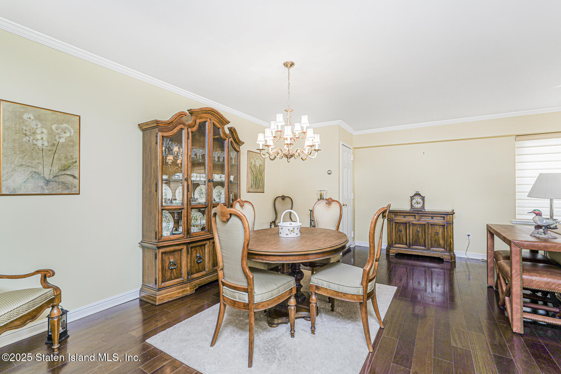 31 Hylan Boulevard, Unit 1B Staten Island, NY 10305 - Photo 11 of 23 a dining room with furniture a chandelier and wooden floor