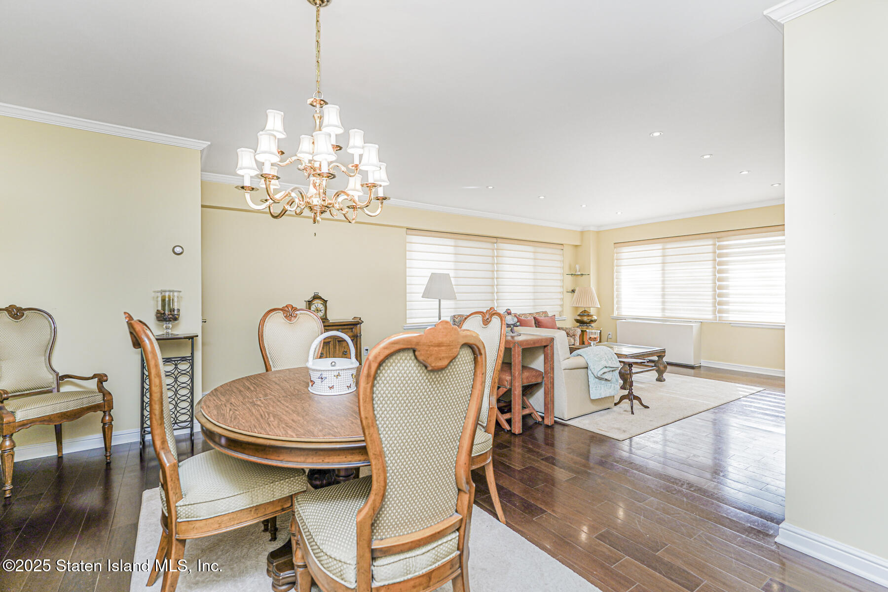 31 Hylan Boulevard, Unit 1B Staten Island, NY 10305 - Photo 12 of 23 a dining room with furniture a chandelier and wooden floor