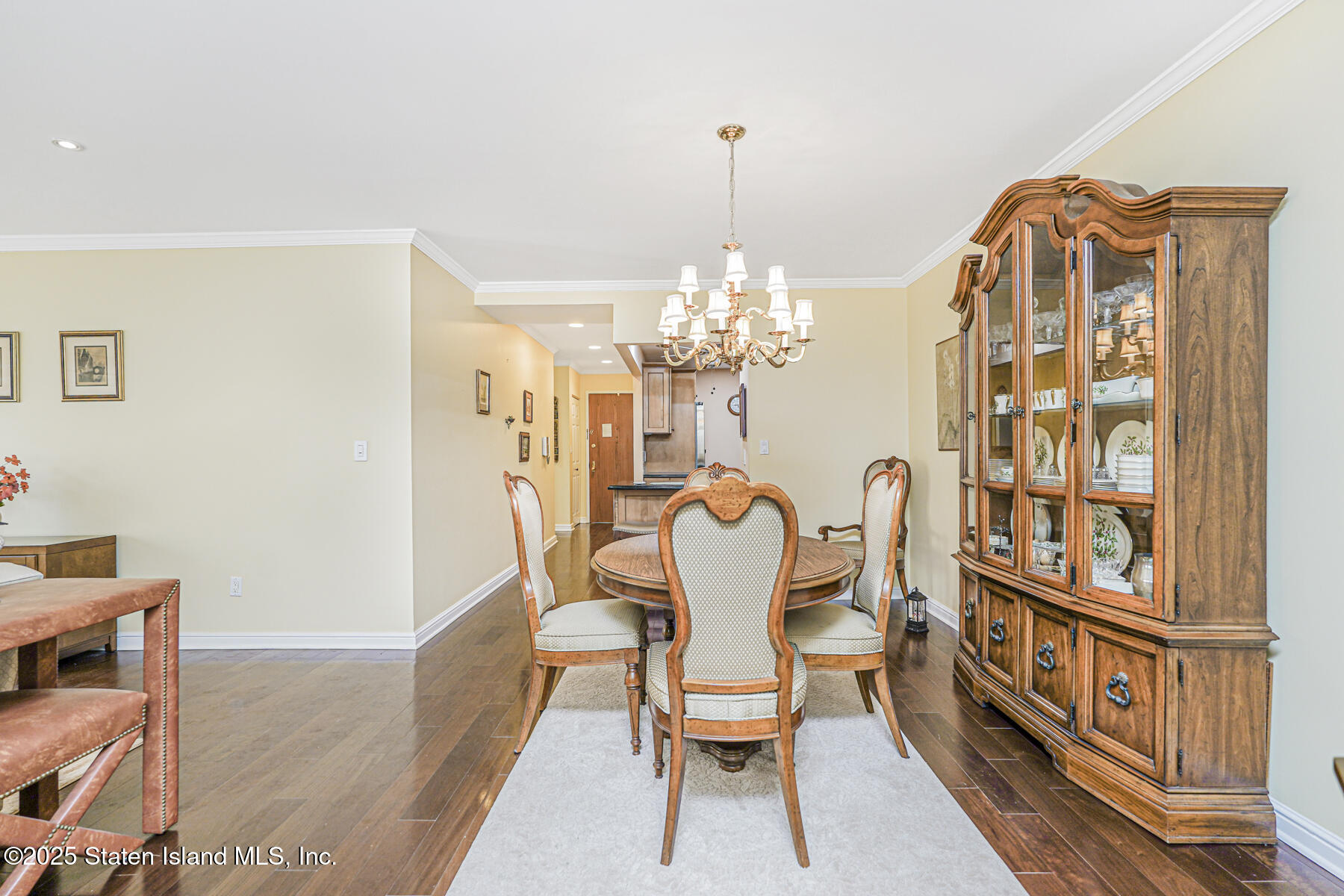 31 Hylan Boulevard, Unit 1B Staten Island, NY 10305 - Photo 15 of 23 a dining room with furniture a chandelier and wooden floor
