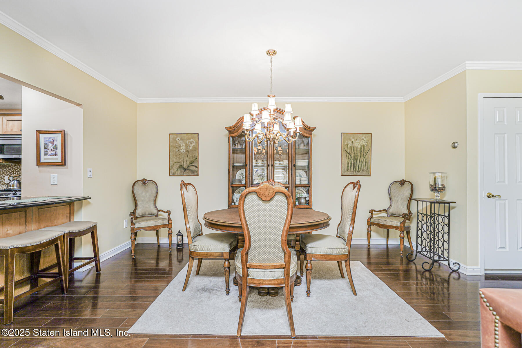 31 Hylan Boulevard, Unit 1B Staten Island, NY 10305 - Photo 16 of 23 a dining room with furniture a chandelier and wooden floor