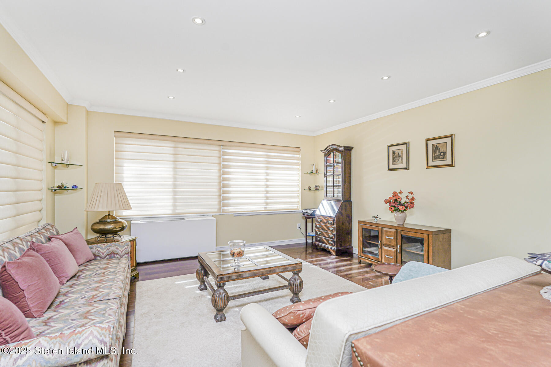 31 Hylan Boulevard, Unit 1B Staten Island, NY 10305 - Photo 17 of 23 a bedroom with a bed and a couch