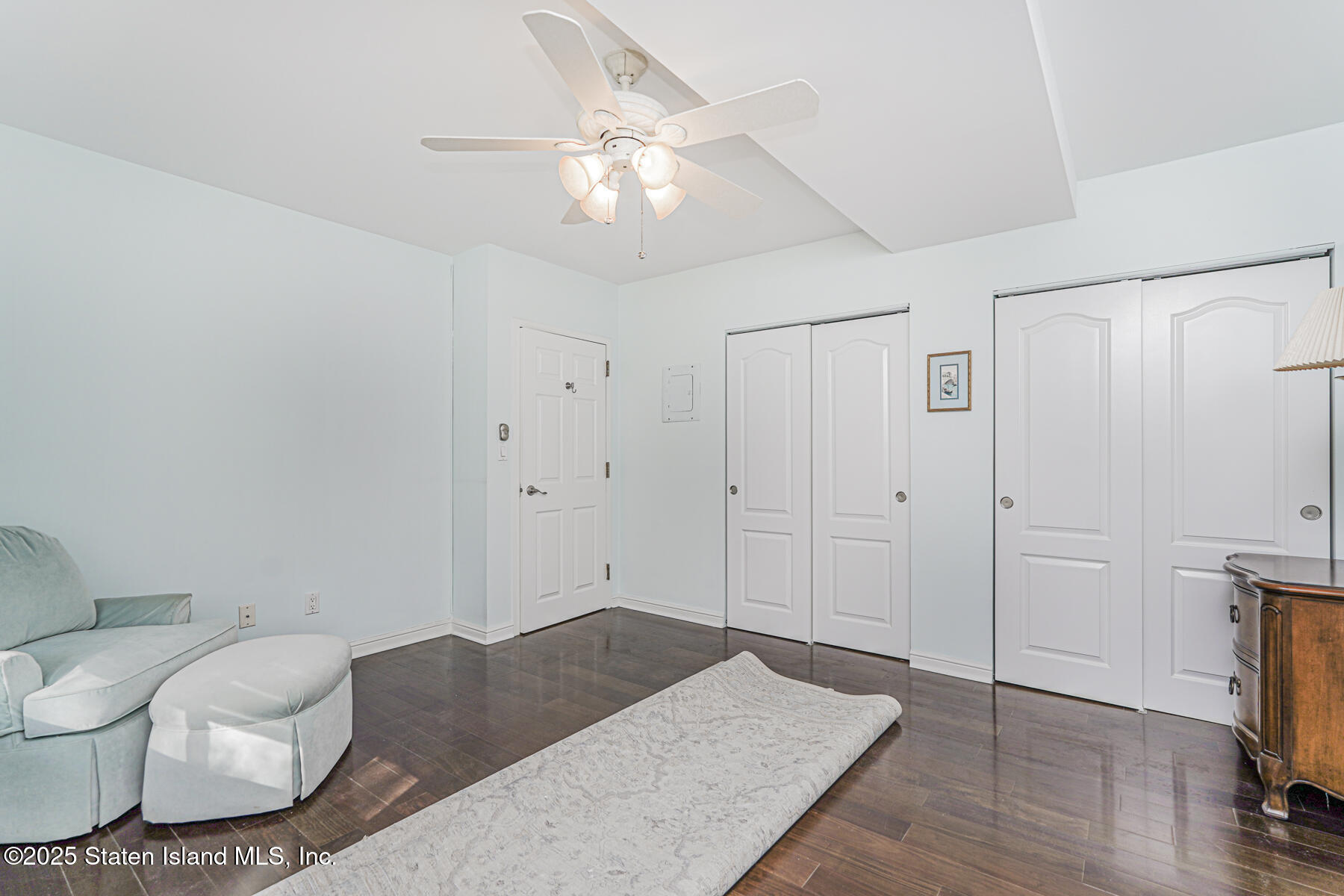 31 Hylan Boulevard, Unit 1B Staten Island, NY 10305 - Photo 22 of 23 a bedroom with a bed and wooden floor