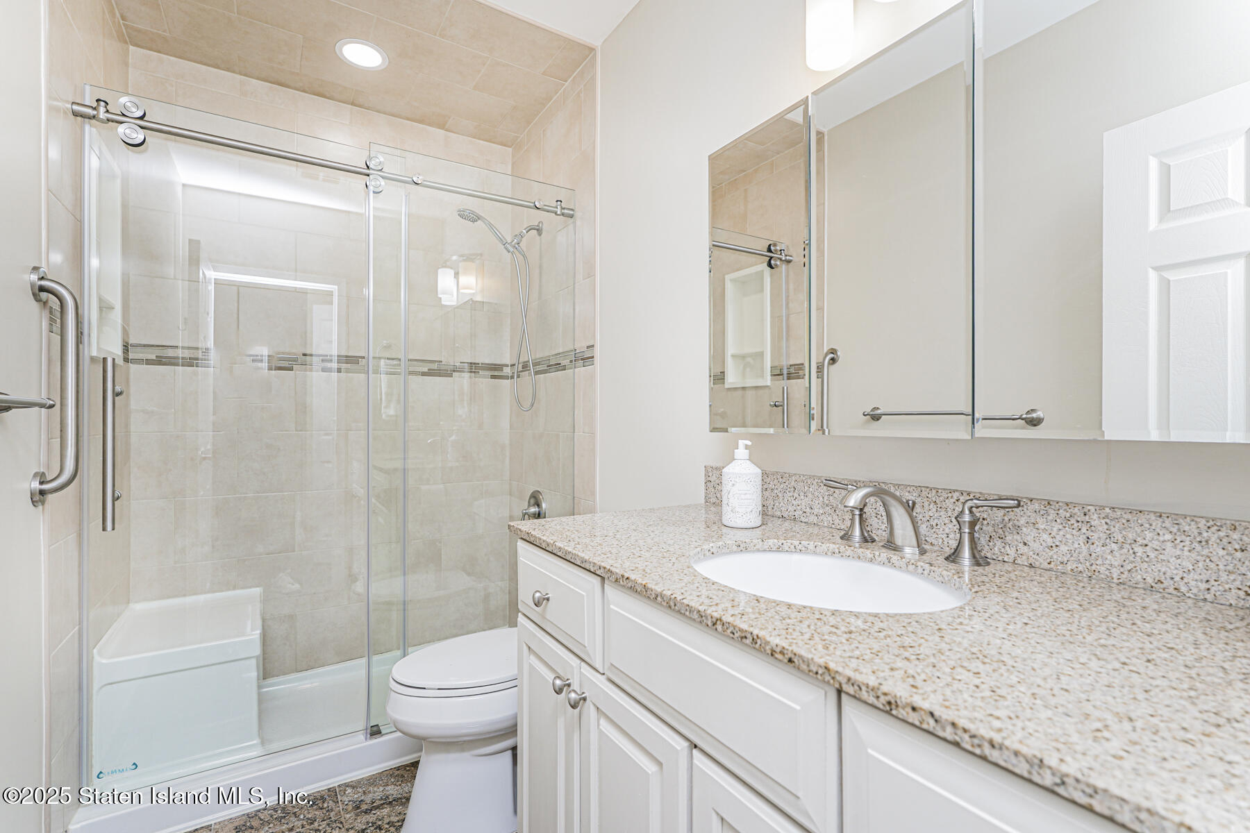 31 Hylan Boulevard, Unit 1B Staten Island, NY 10305 - Photo 23 of 23 a bathroom with a granite countertop sink toilet and shower