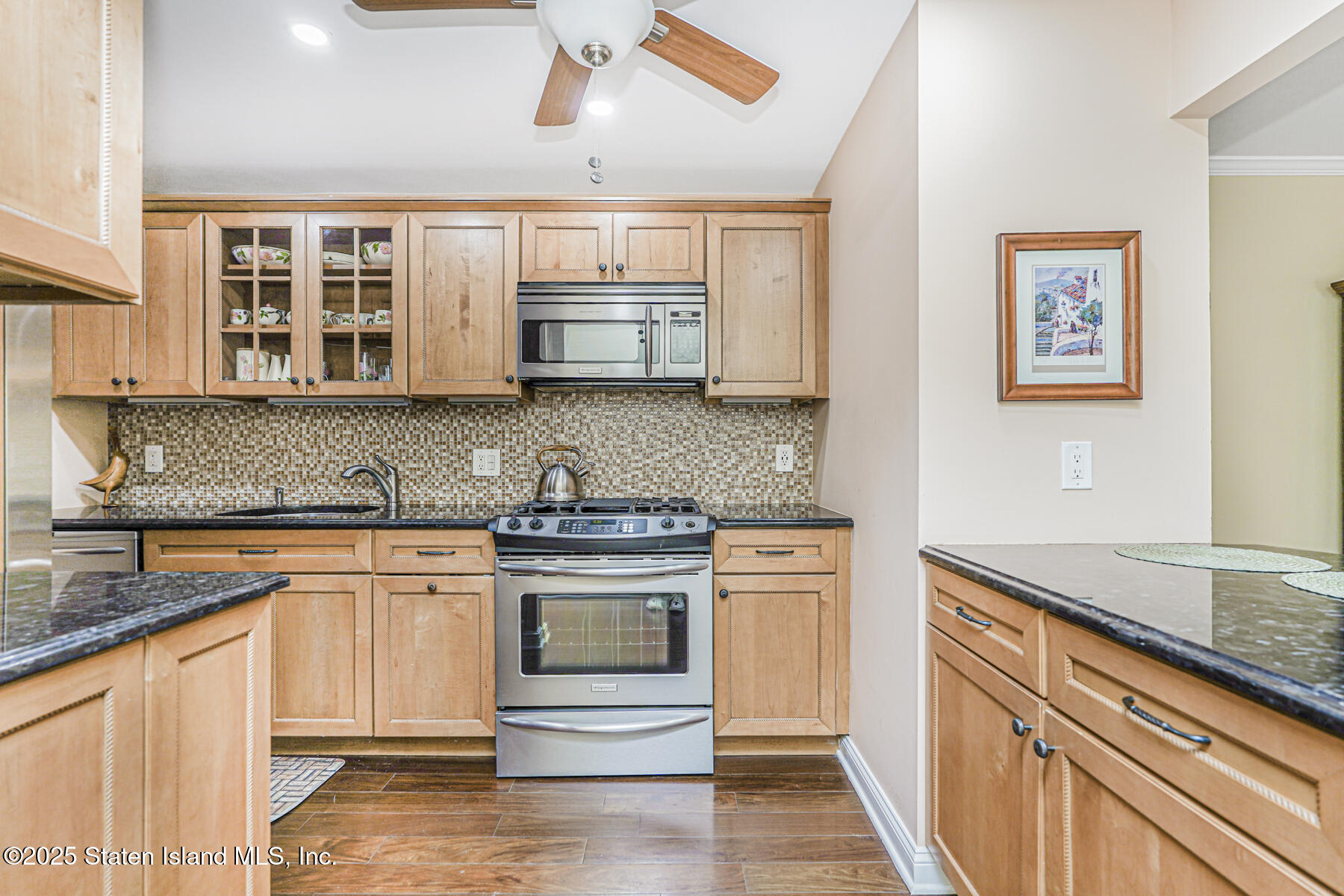 31 Hylan Boulevard, Unit 1B Staten Island, NY 10305 - Photo 7 of 23 a kitchen with stainless steel appliances granite countertop a stove and cabinets