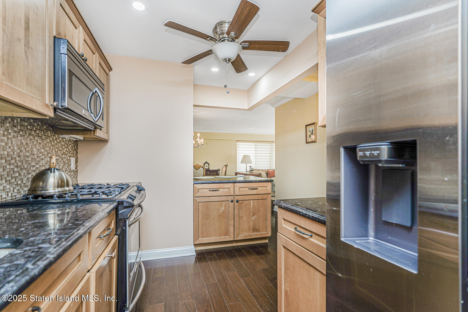 31 Hylan Boulevard, Unit 1B Staten Island, NY 10305 - Photo 9 of 23 a kitchen with granite countertop a sink cabinets stainless steel appliances and a counter top space