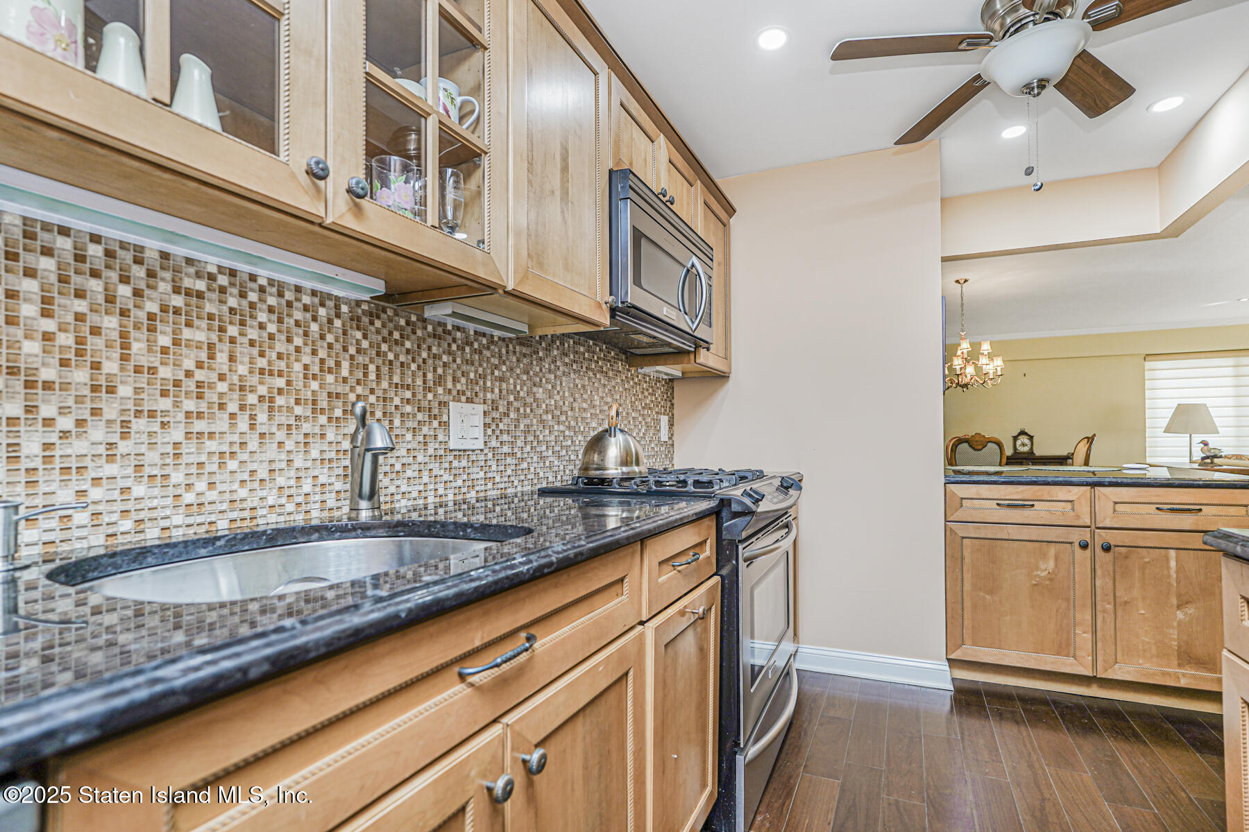 31 Hylan Boulevard, Unit 1B Staten Island, NY 10305 - Photo 10 of 23 a kitchen with granite countertop stainless steel appliances a sink and cabinets