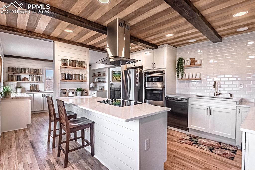 9110 Link Road Fountain, CO 80817 - Photo 12 of 47 a kitchen with stainless steel appliances kitchen island granite countertop a table chairs and a refrigerator