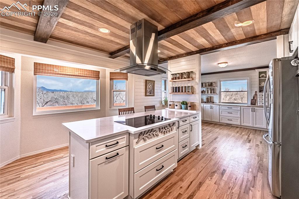 9110 Link Road Fountain, CO 80817 - Photo 13 of 47 a kitchen with cabinets wooden floor and stainless steel appliances