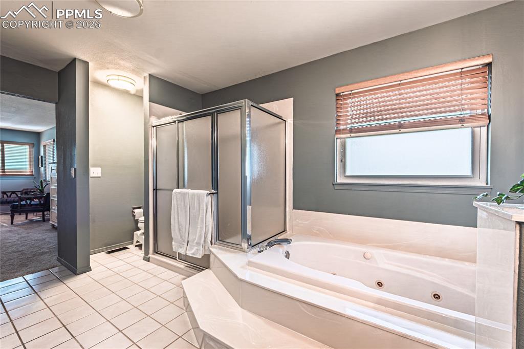 9110 Link Road Fountain, CO 80817 - Photo 23 of 47 a spacious bathroom with a bathtub and a shower