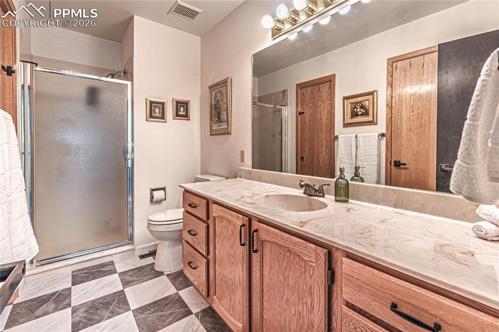 9110 Link Road Fountain, CO 80817 - Photo 25 of 47 a bathroom with a granite countertop sink and a mirror
