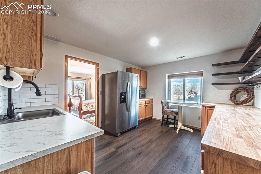9110 Link Road Fountain, CO 80817 - Photo 30 of 47 a view of a kitchen area with furniture and wooden floor