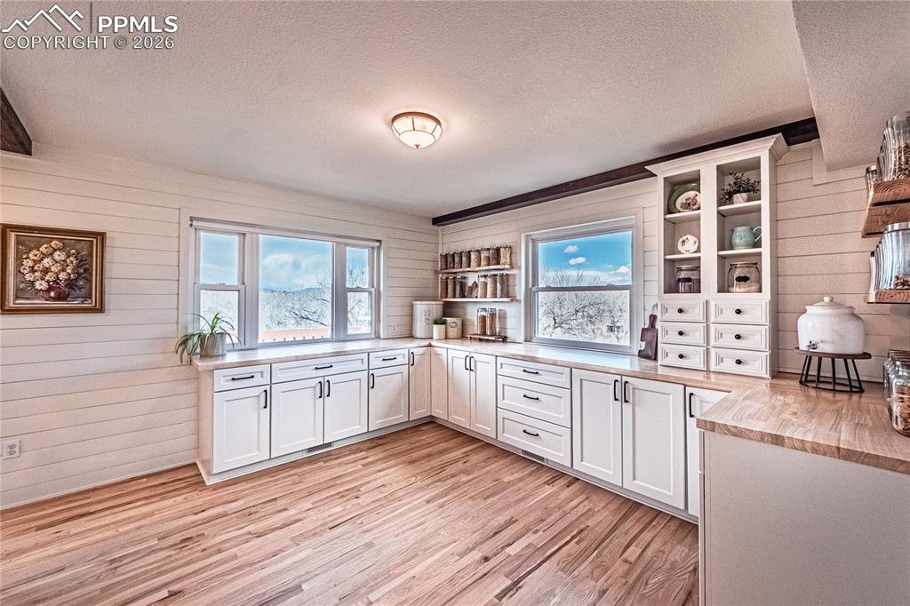 9110 Link Road Fountain, CO 80817 - Photo 7 of 47 a large kitchen with stainless steel appliances granite countertop a stove a sink dishwasher and white cabinets with wooden floor