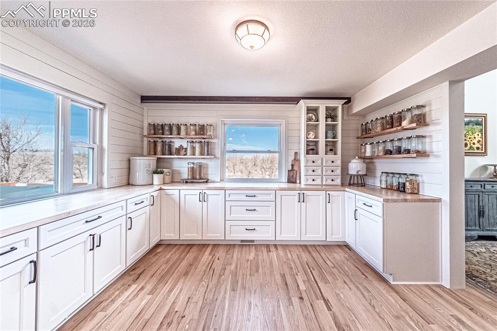 9110 Link Road Fountain, CO 80817 - Photo 8 of 47 a open kitchen with white cabinets and wooden floor