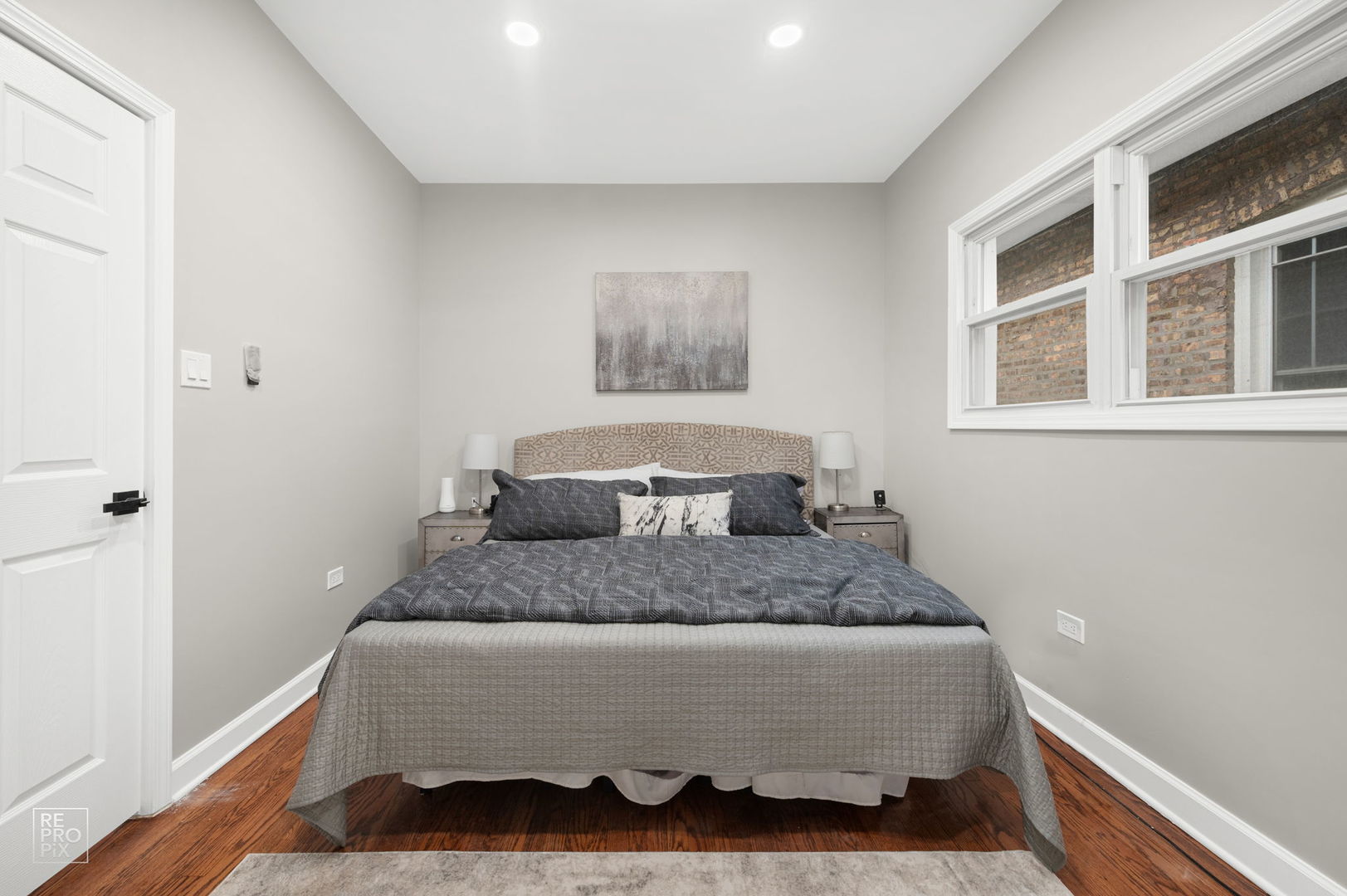 7425 South Vernon Avenue Chicago, IL 60619 - Photo 6 of 15 a bedroom with a bed and wooden floor