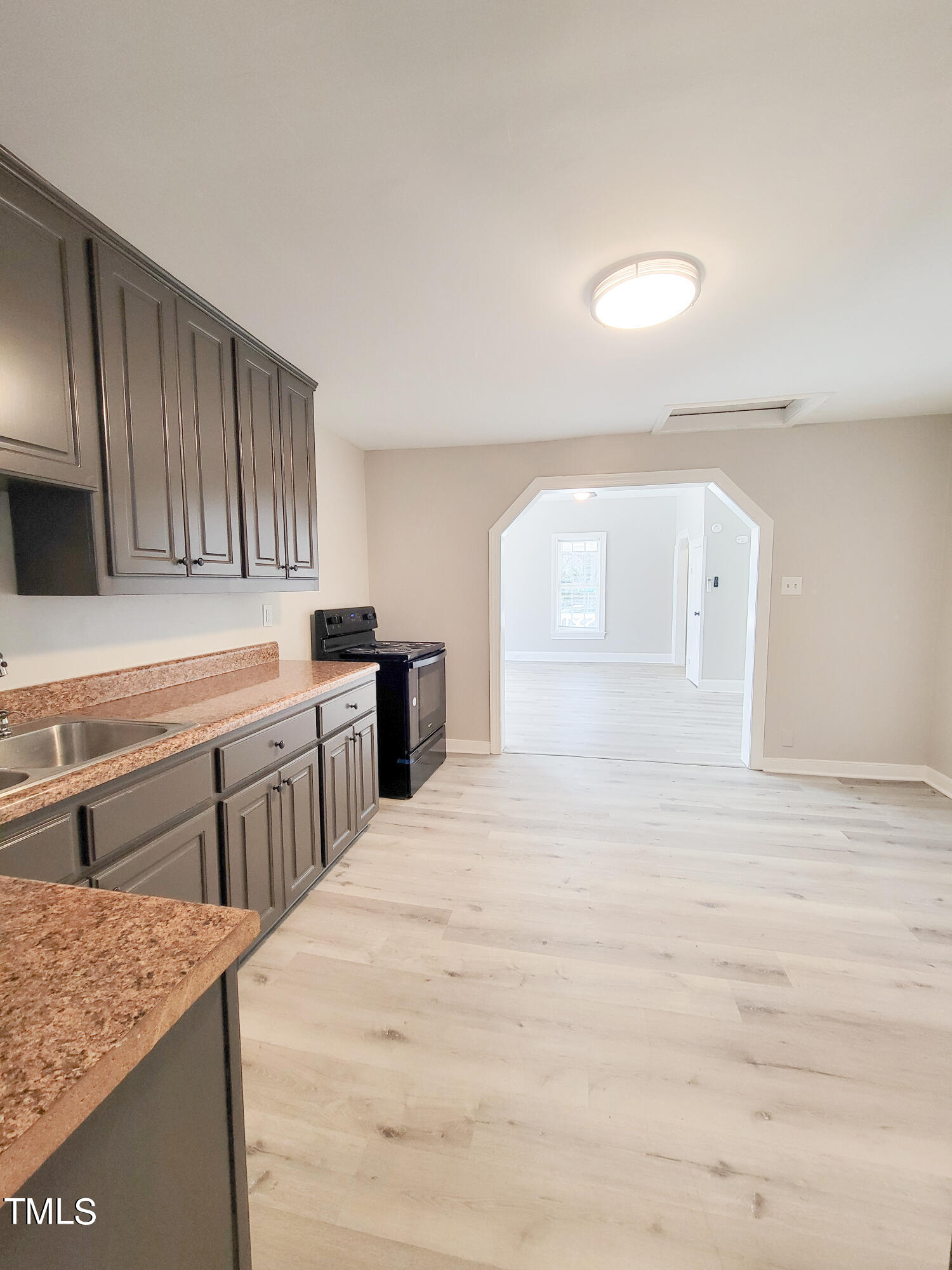 1611 Cross Street Raleigh, NC 27610 - Photo 13 of 22 a kitchen with stainless steel appliances granite countertop a sink stove and cabinets