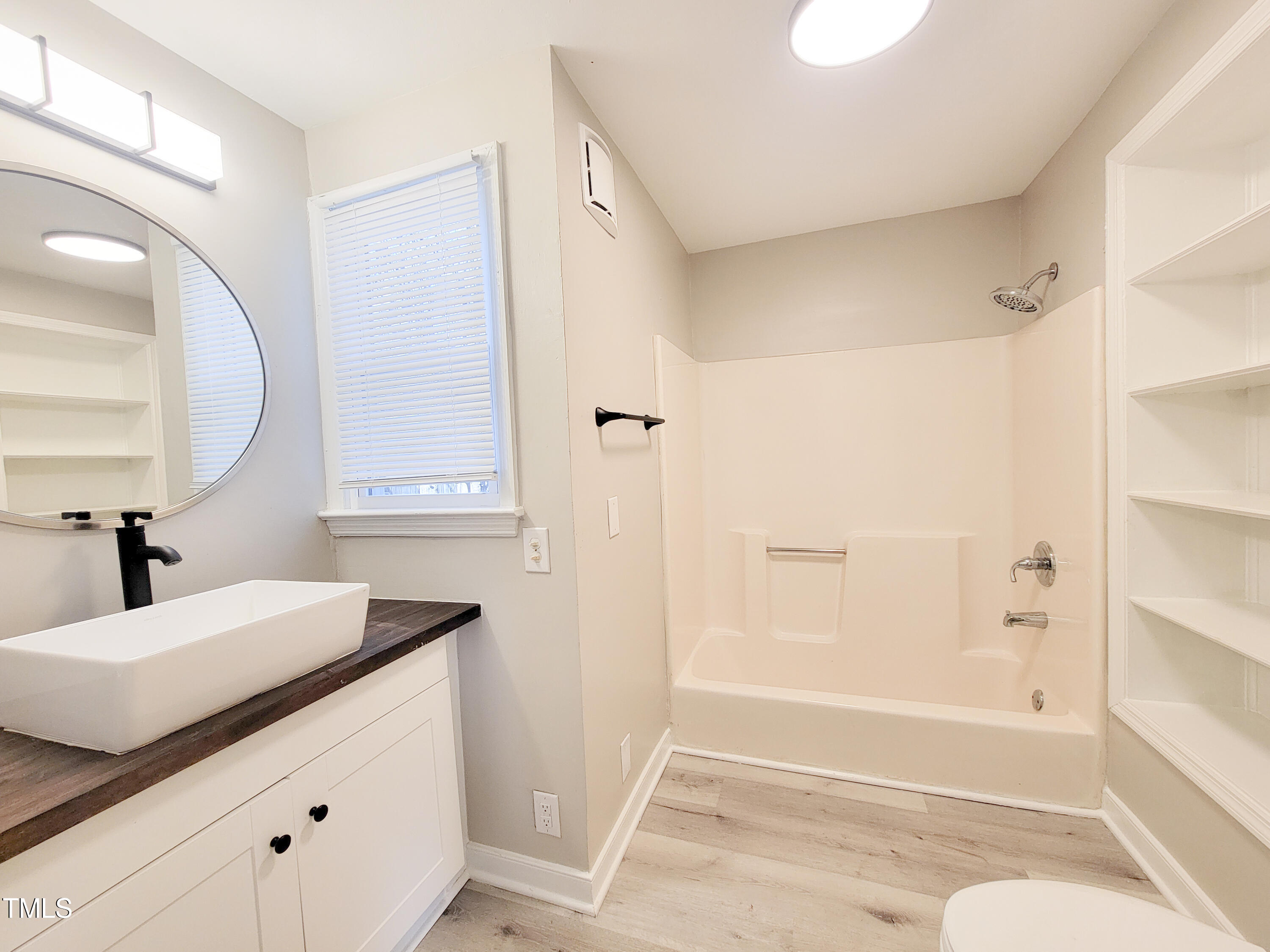 1611 Cross Street Raleigh, NC 27610 - Photo 18 of 22 a bathroom with a bathtub and a sink