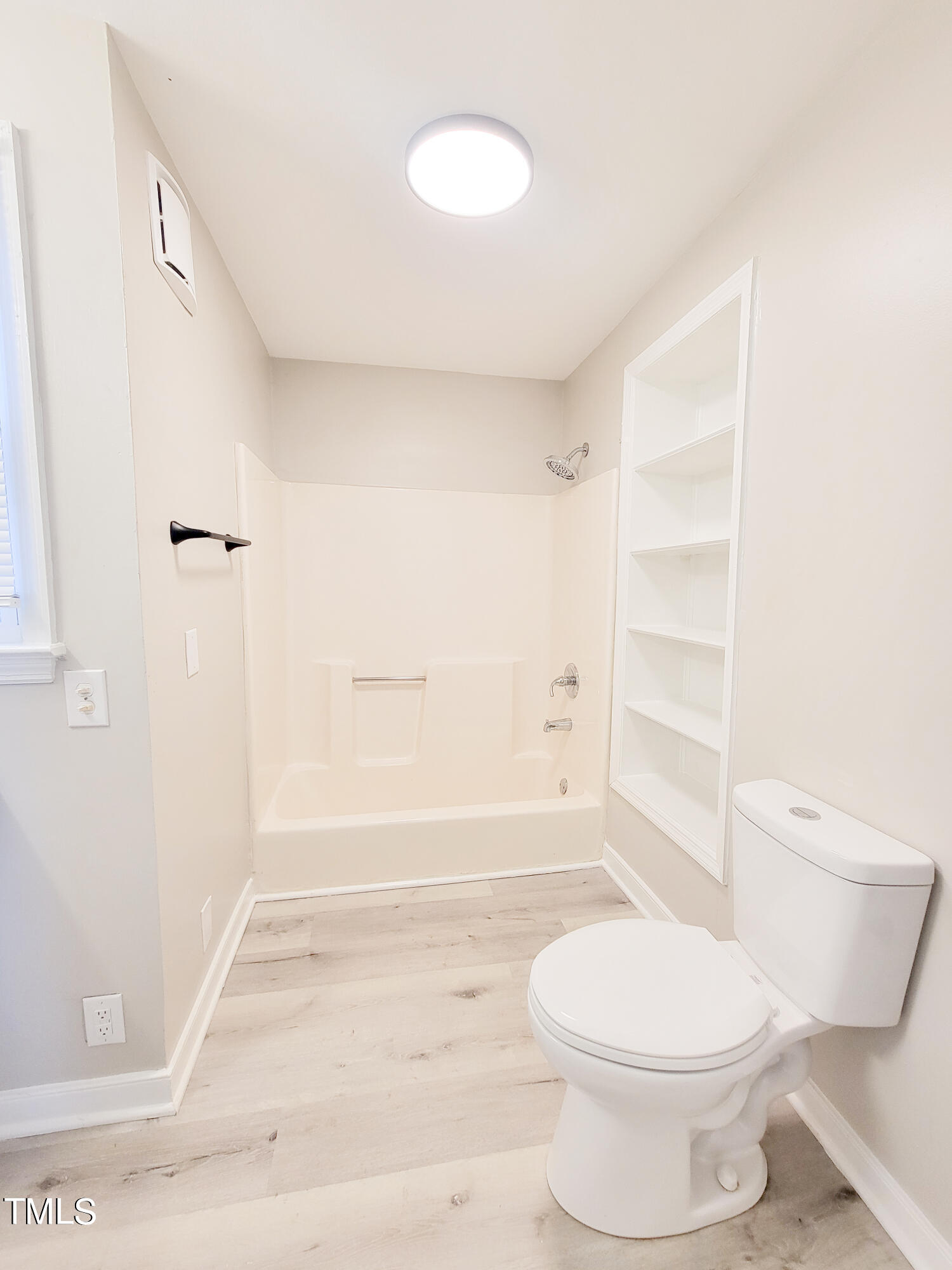 1611 Cross Street Raleigh, NC 27610 - Photo 20 of 22 a bathroom with a toilet and a shower