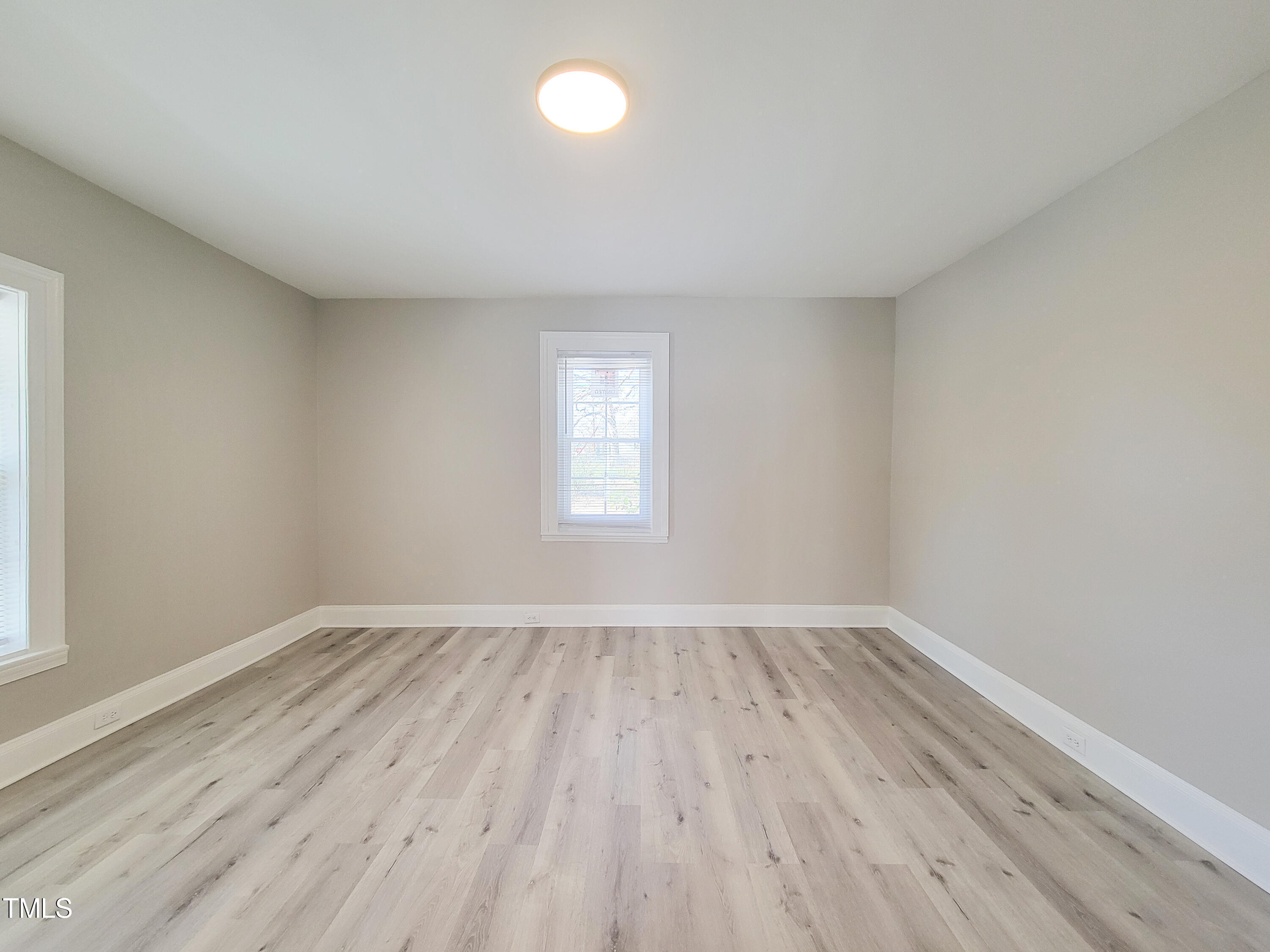 1611 Cross Street Raleigh, NC 27610 - Photo 8 of 22 an empty room with wooden floor and windows