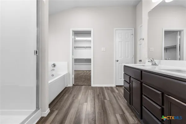 a white bath tub sitting next to a white sink