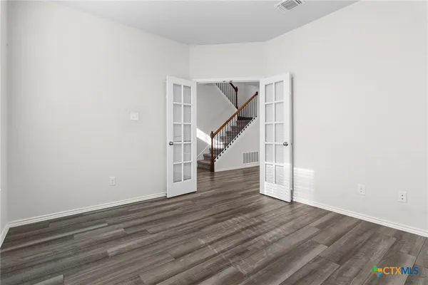 a view of entryway and hall with wooden floor