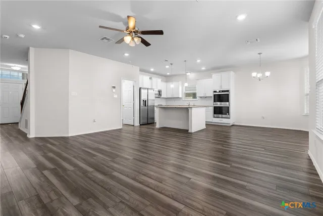 a view of kitchen with cabinets and wooden floor