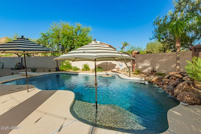 a backyard of a house with table and chairs