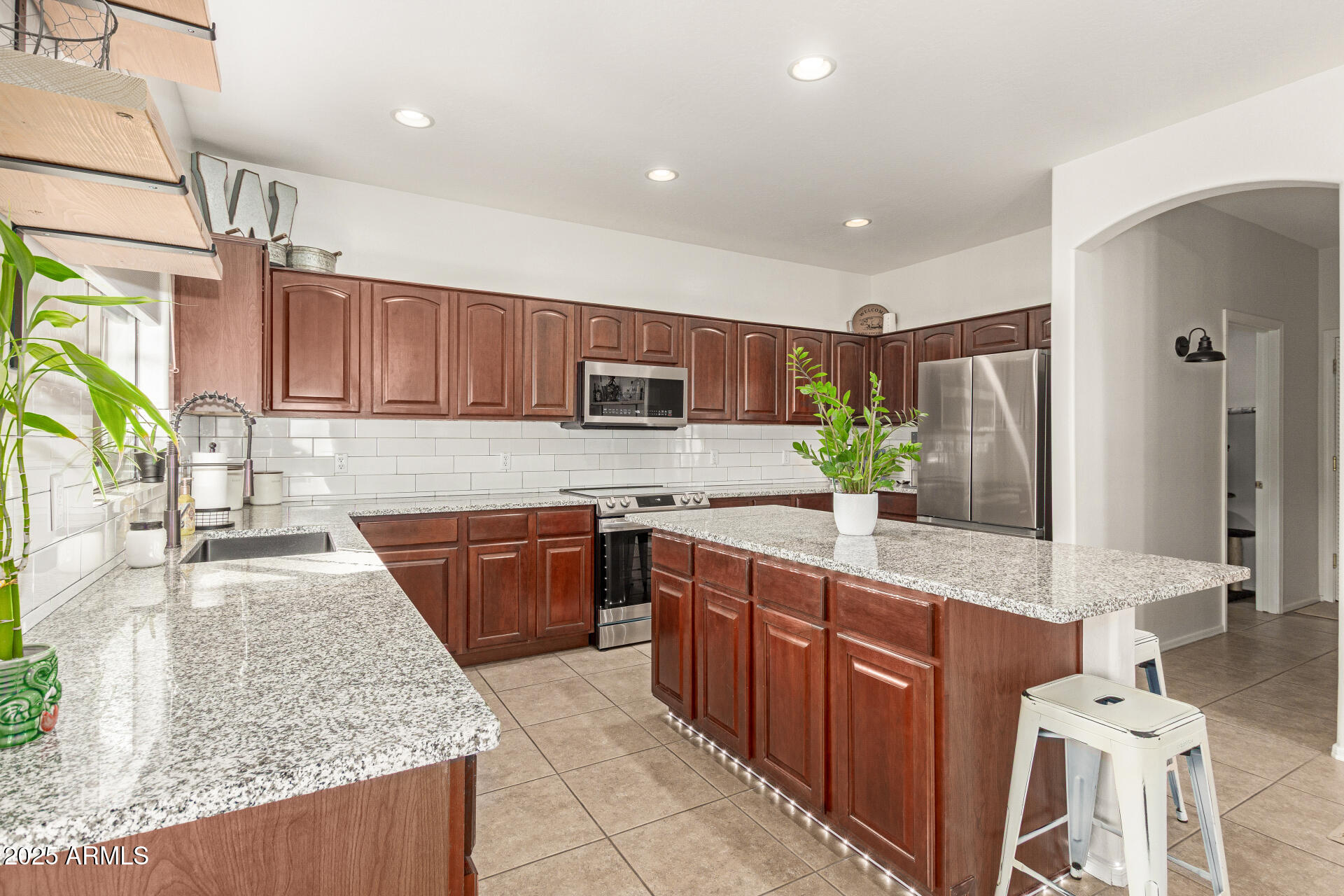 6003 West Oberlin Way Phoenix, AZ 85083 - Photo 11 of 69 a large kitchen with stainless steel appliances granite countertop a sink stove and refrigerator
