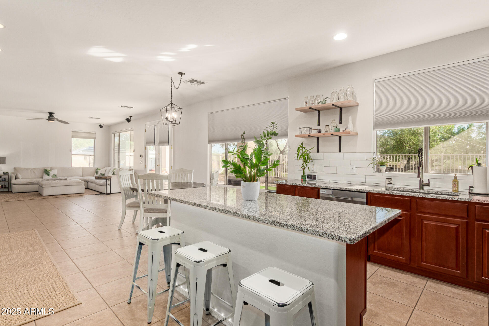 6003 West Oberlin Way Phoenix, AZ 85083 - Photo 12 of 69 a kitchen with stainless steel appliances granite countertop a sink counter space and living room view