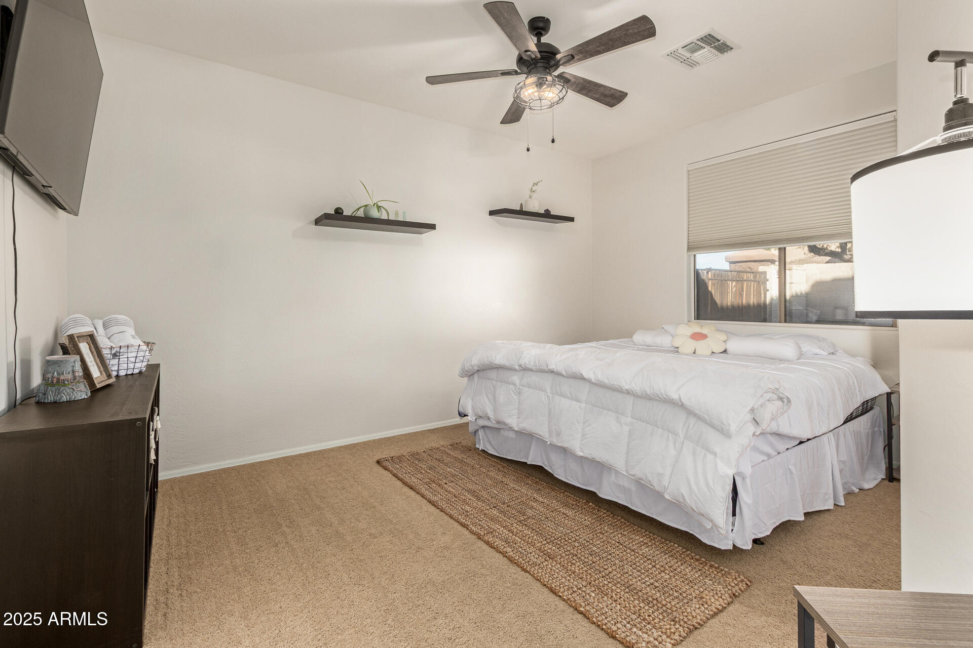 6003 West Oberlin Way Phoenix, AZ 85083 - Photo 27 of 69 a bedroom with a bed and a flat tv screen on the dresser