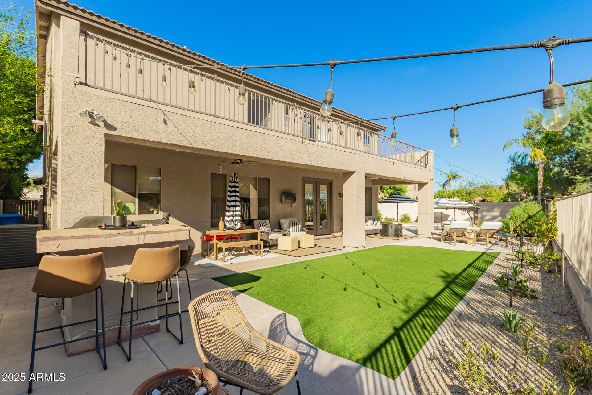 6003 West Oberlin Way Phoenix, AZ 85083 - Photo 51 of 69 a view of a patio with table and chairs potted plants and large tree