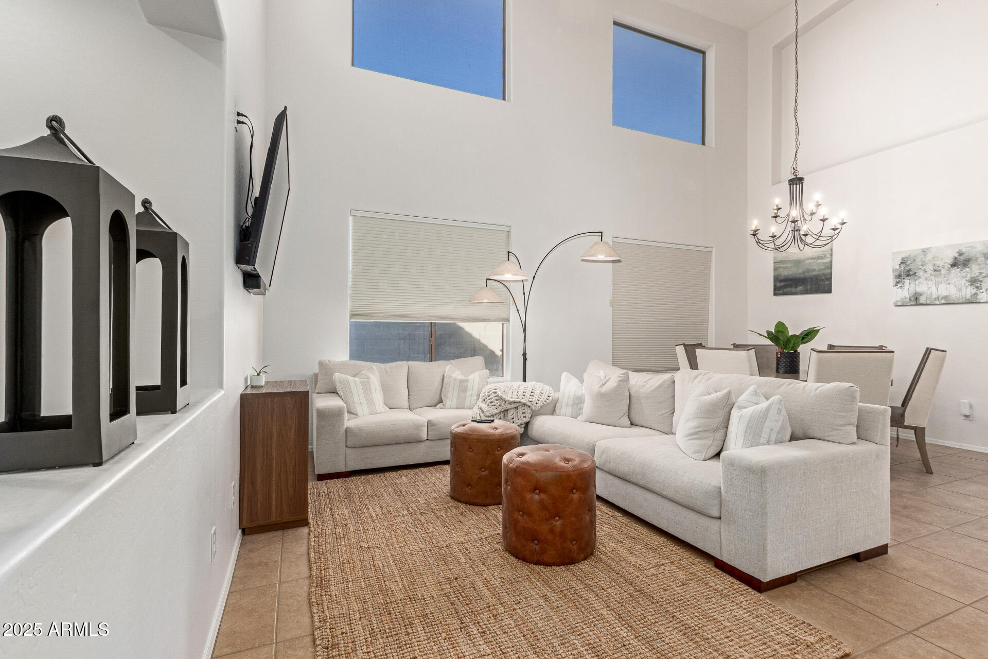 6003 West Oberlin Way Phoenix, AZ 85083 - Photo 8 of 69 a living room with furniture a fireplace and a chandelier