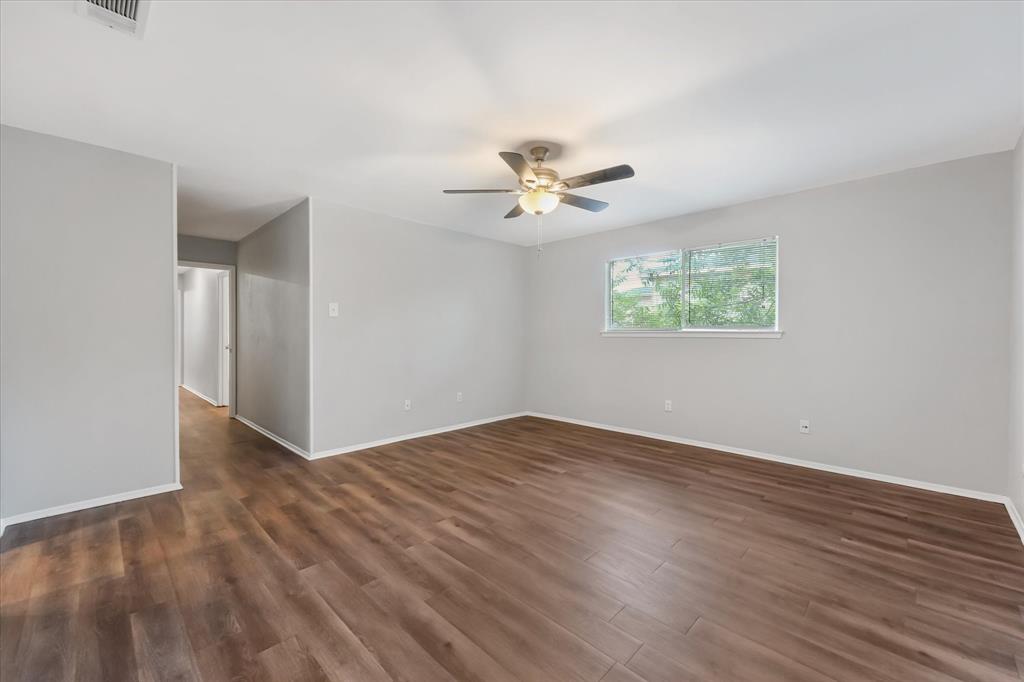 4005 Ridgebrook Drive Arlington, TX 76015 - Photo 12 of 18 Spacious primary bedroom featuring wood-finish flooring and a neutral color palette