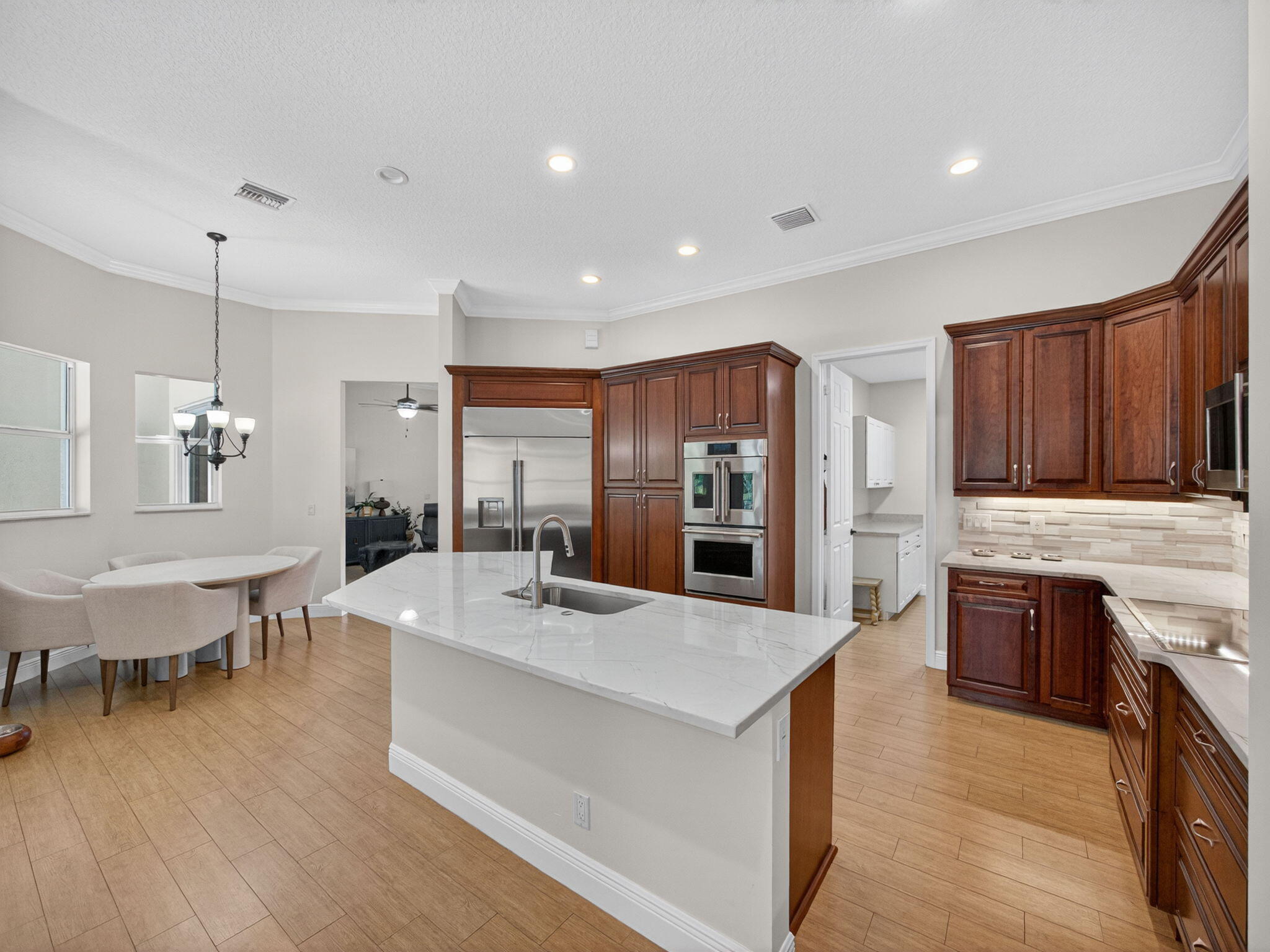 17593 Winterhawk Trail Jupiter, FL 33478 - Photo 18 of 49 a large kitchen with stainless steel appliances lots of counter space and breakfast area