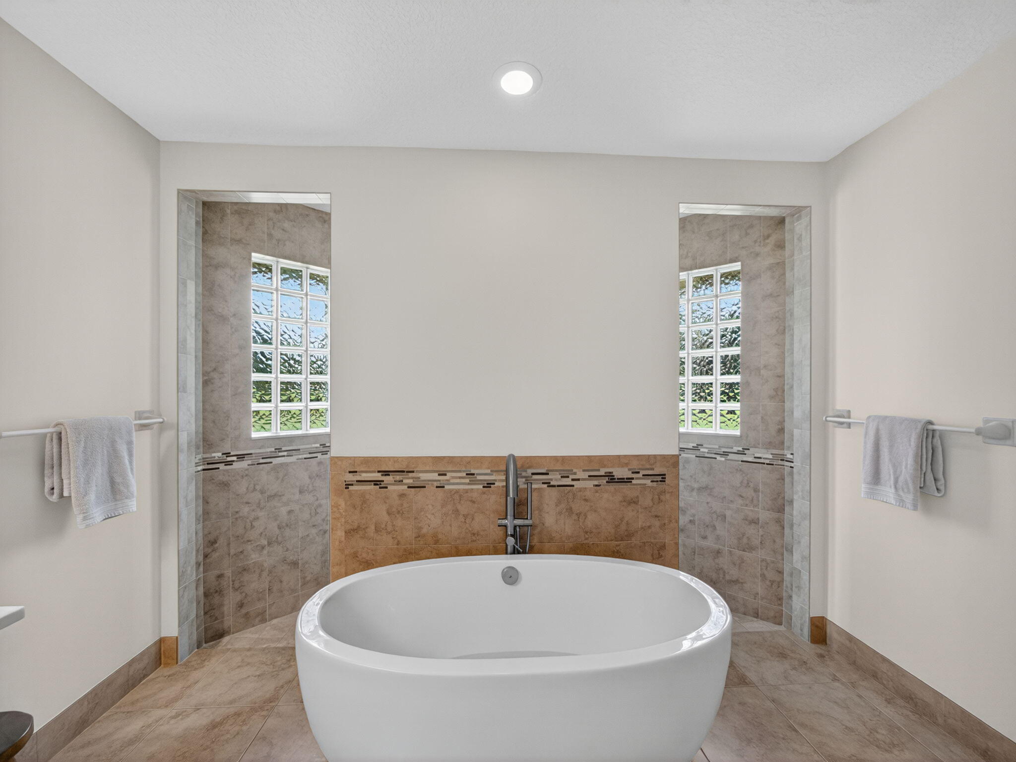 17593 Winterhawk Trail Jupiter, FL 33478 - Photo 21 of 49 a bathroom with a bathtub and shower