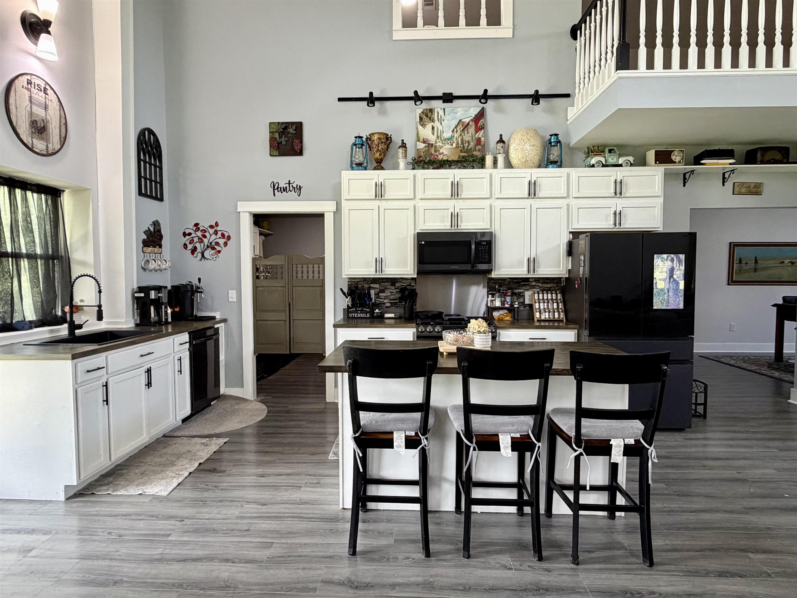 3670 Peavine Road Middleton, TN 38052 - Photo 8 of 36 Spacious kitchen featuring an expansive island, white cabinetry, dark countertops, and black appliances