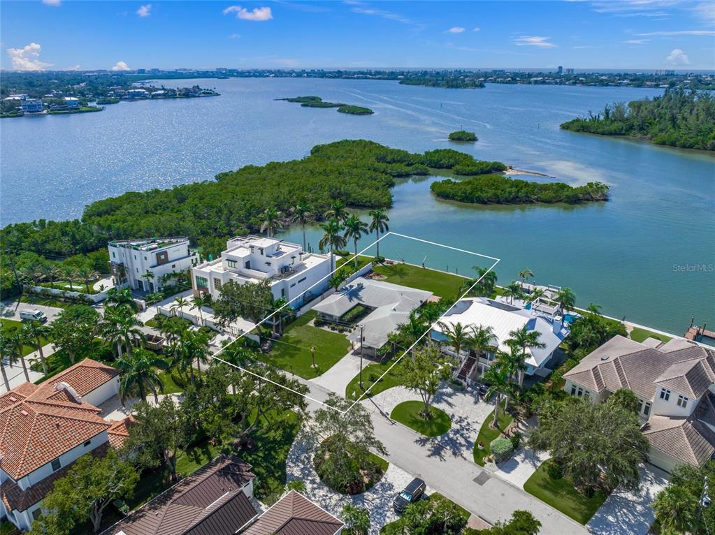 an aerial view of lake and residential houses with outdoor space