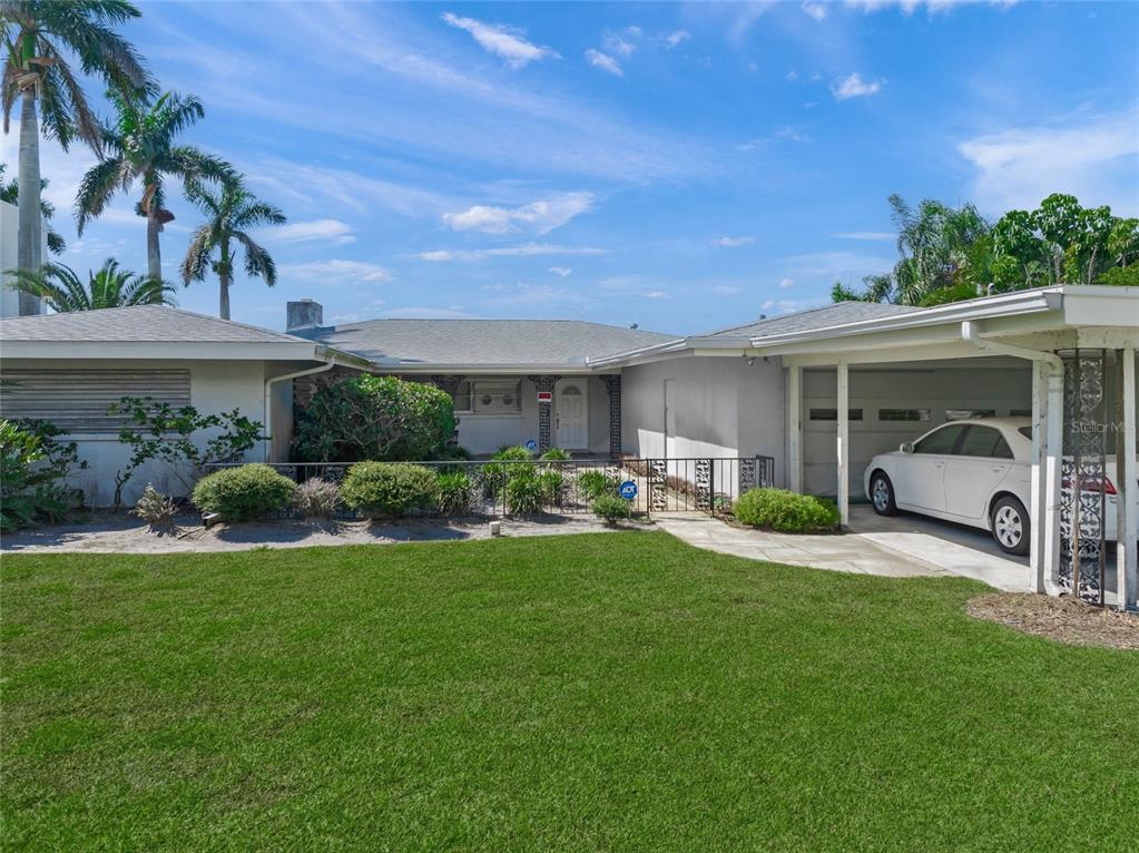 1386 Tangier Way Sarasota, FL 34239 - Photo 11 of 26 a view of a house with backyard sitting area and garden