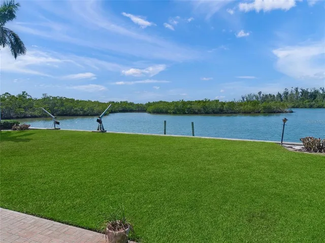 a view of a lake with houses in the back