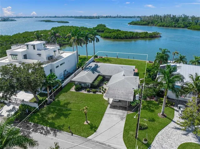 an aerial view of a house with garden space and lake view