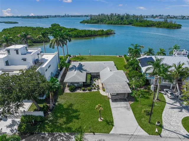 an aerial view of a house with outdoor space and lake view