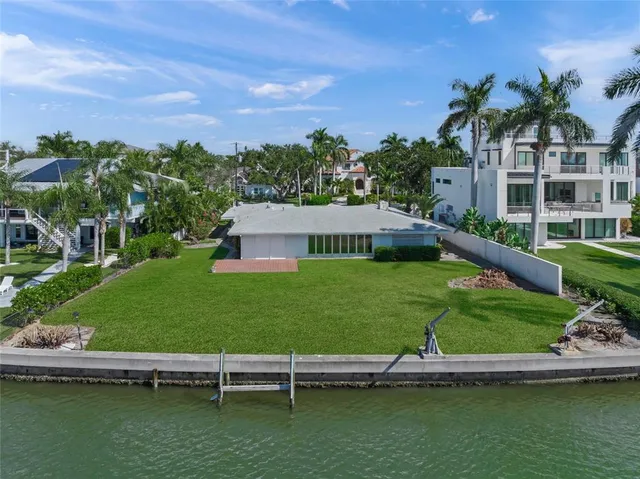 a view of an house with backyard and a patio