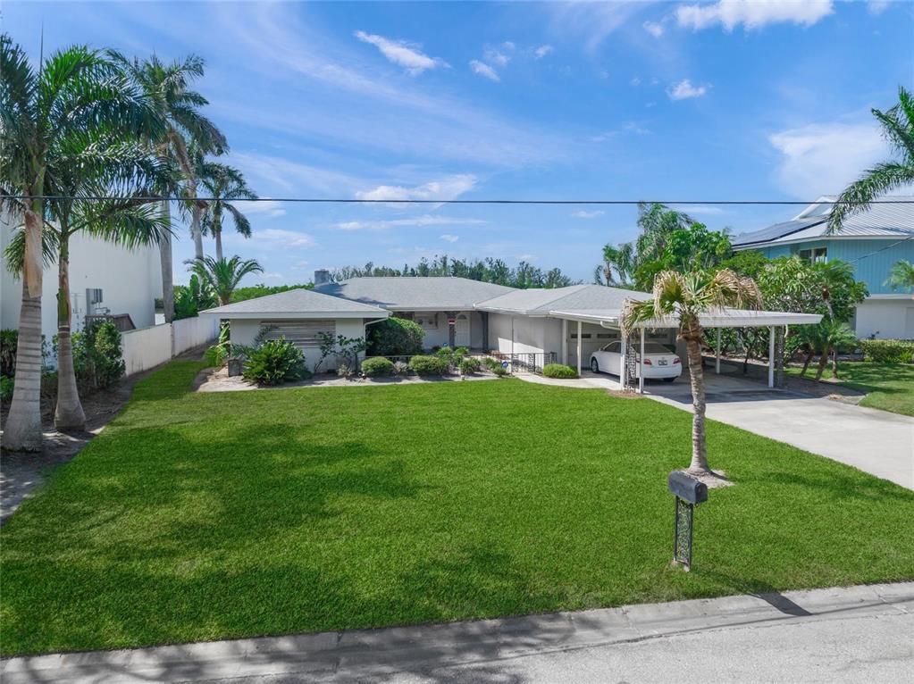 1386 Tangier Way Sarasota, FL 34239 - Photo 7 of 26 a view of an house with backyard and a patio