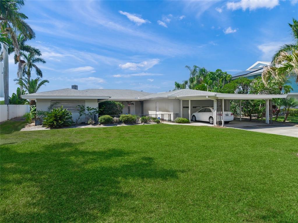 1386 Tangier Way Sarasota, FL 34239 - Photo 8 of 26 a front view of a house with a yard