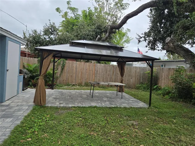 a view of backyard with a barn and a cactus plant
