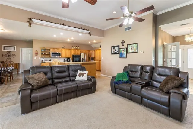 a living room with furniture and a chandelier