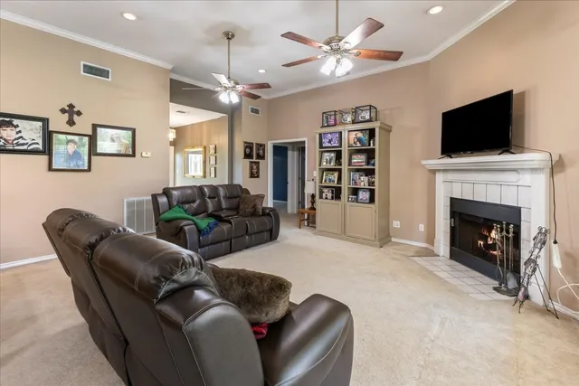 a living room with furniture a flat screen tv and a fireplace