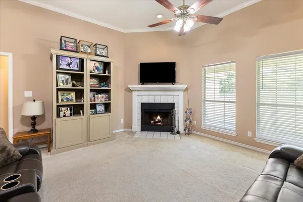 a living room with furniture a flat screen tv and a fireplace