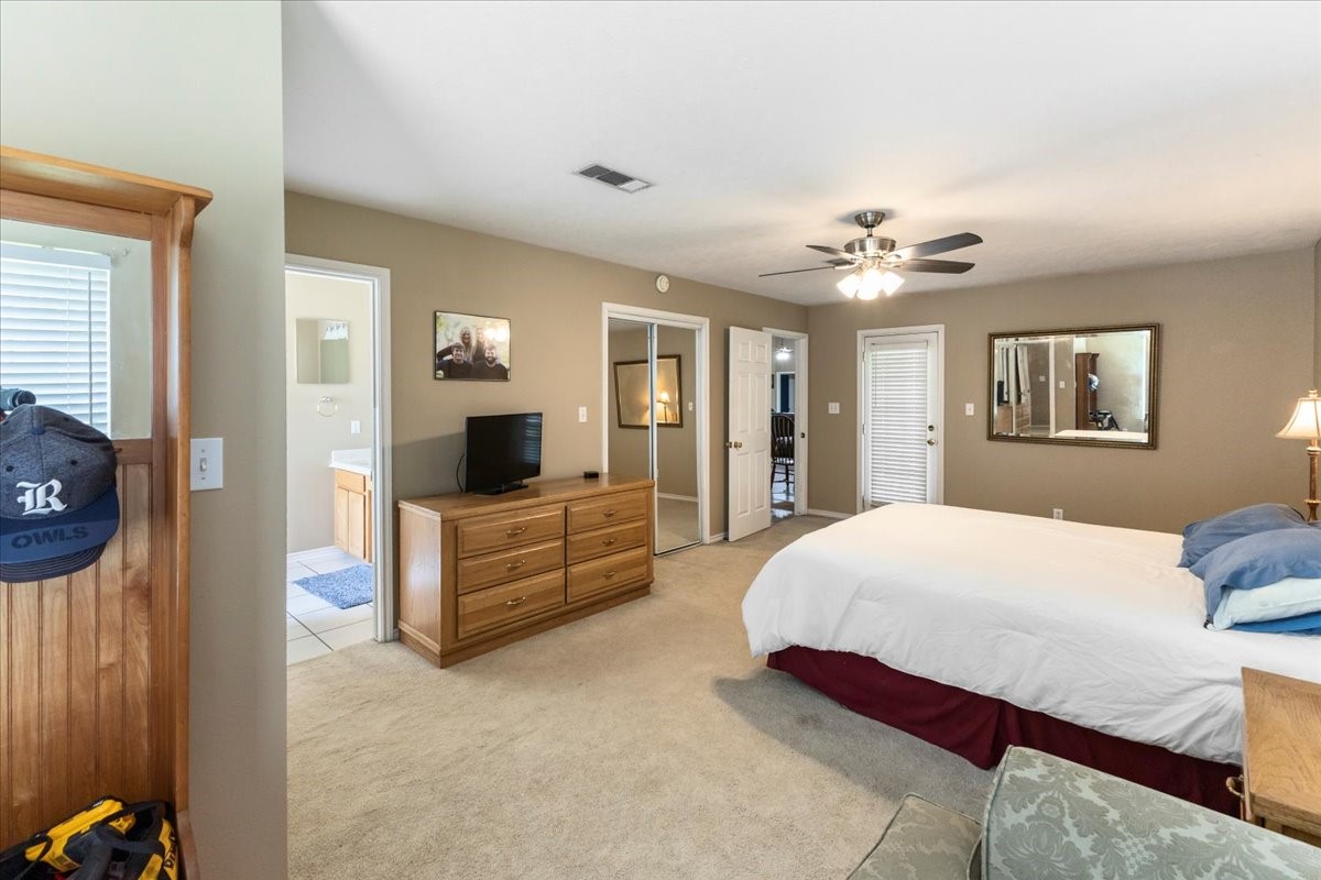 544 Meadow Lane Winnie, TX 77665 - Photo 24 of 38 a bedroom with a bed and a chandelier