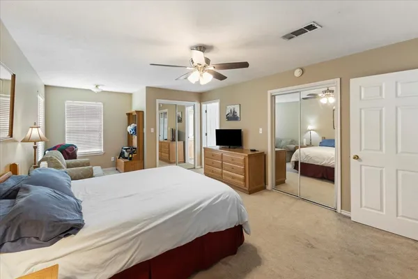 a bedroom with a bed and ceiling fan